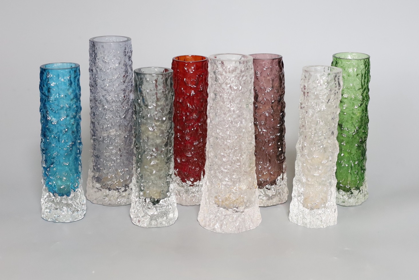 A group of eight Whitefriars 'bark' vases designed by Geoffrey Baxter, various colours, two 15cm high, six 14cm high.